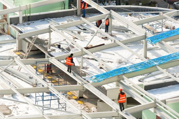 Construction site with workers on the building roof